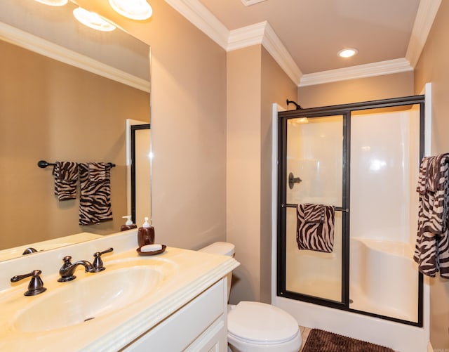 bathroom with toilet, a shower stall, crown molding, and vanity