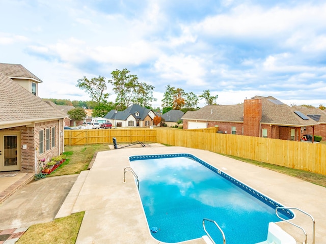 view of swimming pool with a patio, a residential view, a fenced backyard, and a fenced in pool