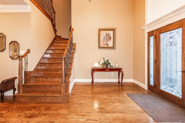 foyer with plenty of natural light, wood finished floors, and baseboards