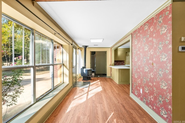 unfurnished sunroom featuring a wood stove