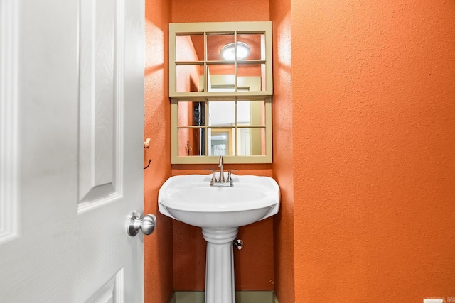 bathroom with a textured wall