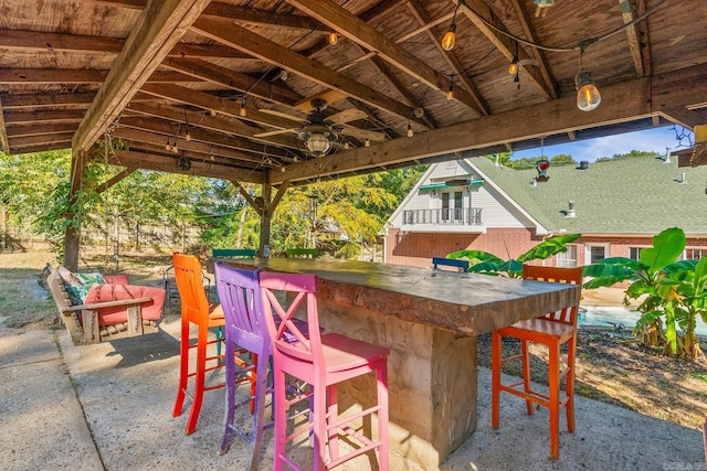 view of patio / terrace featuring outdoor dry bar and ceiling fan