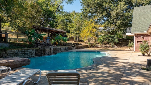 outdoor pool with a gazebo, fence, and a patio