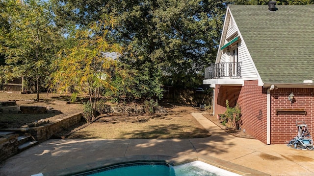 outdoor pool with a patio and fence