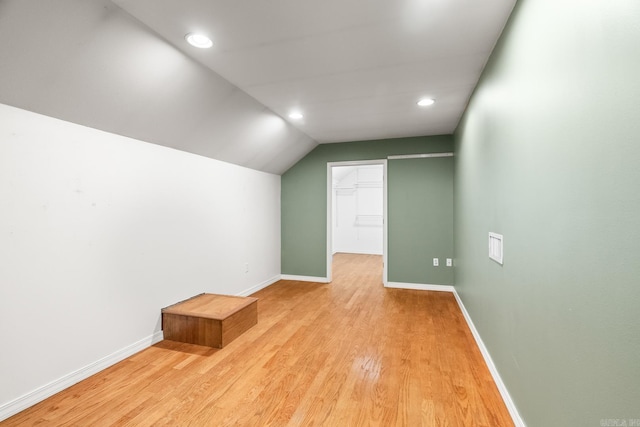 bonus room with light wood-type flooring, vaulted ceiling, baseboards, and recessed lighting