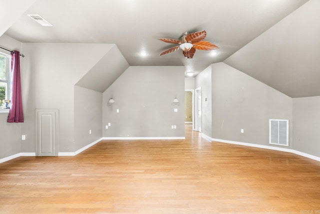 bonus room featuring vaulted ceiling, light wood-style flooring, visible vents, and a ceiling fan