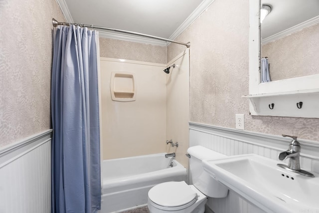 bathroom with crown molding, wainscoting, a sink, and shower / bath combo with shower curtain