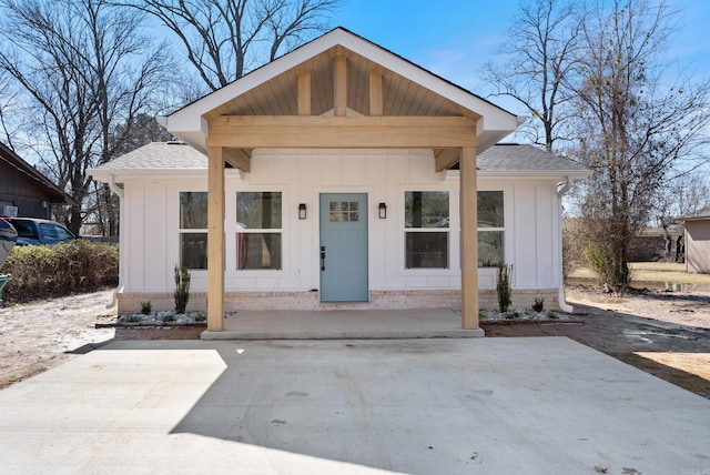 bungalow-style home featuring a shingled roof and board and batten siding