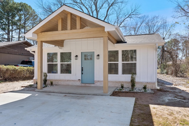 view of front of property featuring a shingled roof and board and batten siding