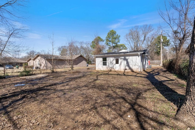 rear view of house featuring fence