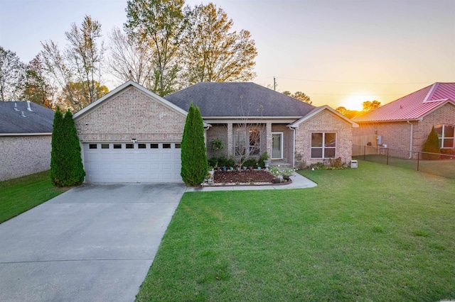 view of front facade featuring brick siding, concrete driveway, a front yard, fence, and a garage