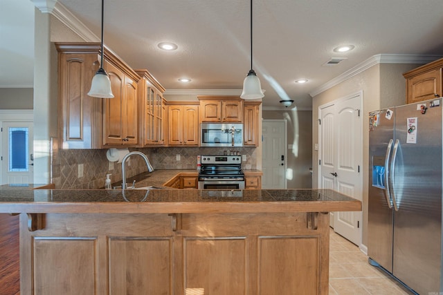 kitchen with glass insert cabinets, a peninsula, stainless steel appliances, crown molding, and backsplash