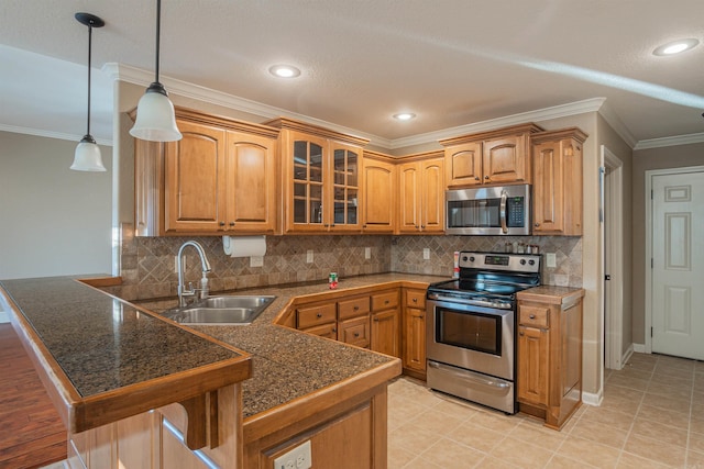 kitchen featuring tile countertops, stainless steel appliances, a peninsula, a sink, and glass insert cabinets