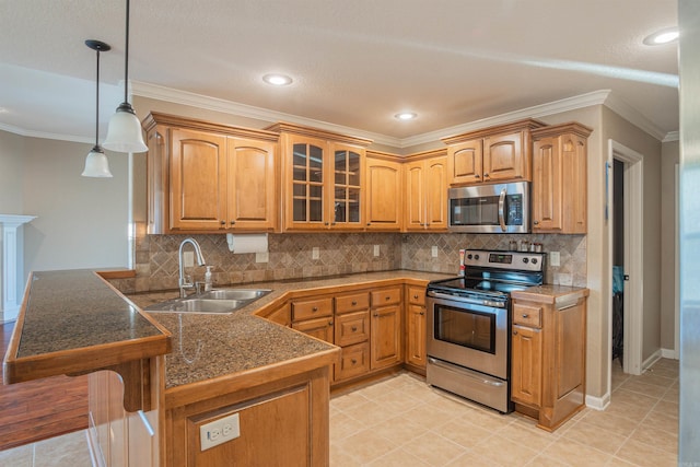 kitchen with tile countertops, a peninsula, a sink, appliances with stainless steel finishes, and glass insert cabinets