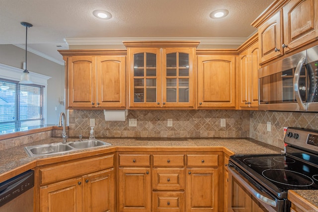 kitchen featuring stainless steel appliances, tile counters, hanging light fixtures, glass insert cabinets, and a sink