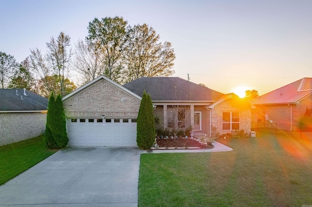 single story home with brick siding, a shingled roof, concrete driveway, an attached garage, and a front lawn