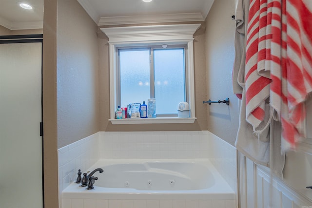 bathroom featuring a textured wall, a stall shower, crown molding, and a whirlpool tub