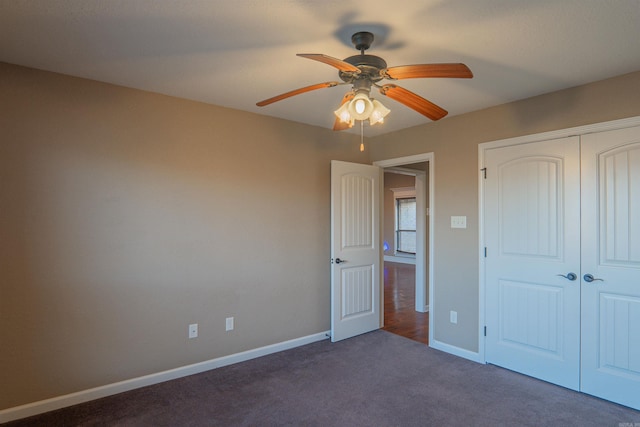 unfurnished bedroom with ceiling fan, a closet, carpet, and baseboards