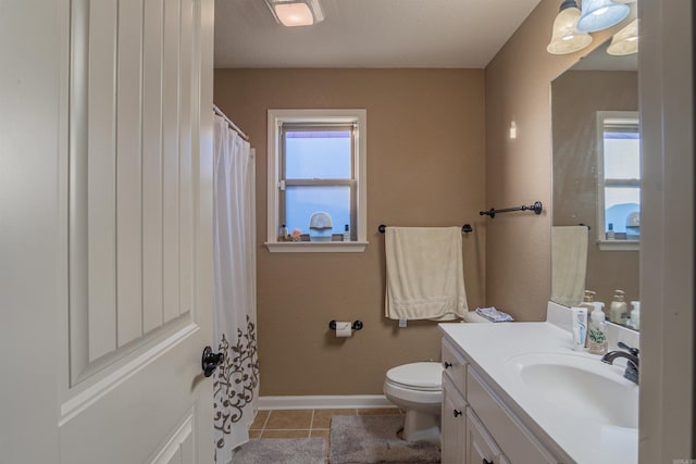 full bathroom with a wealth of natural light, vanity, toilet, and tile patterned floors