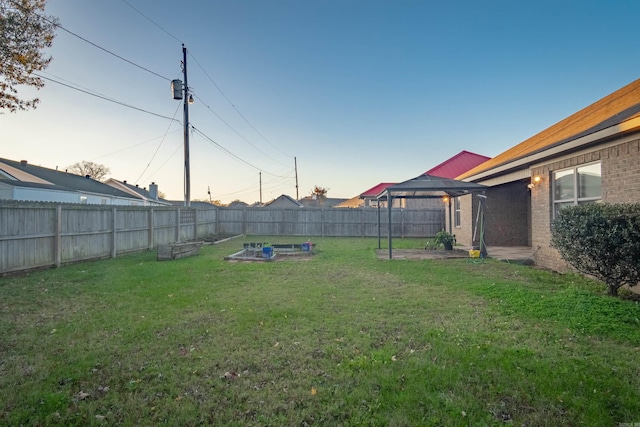 view of yard with a garden and a fenced backyard