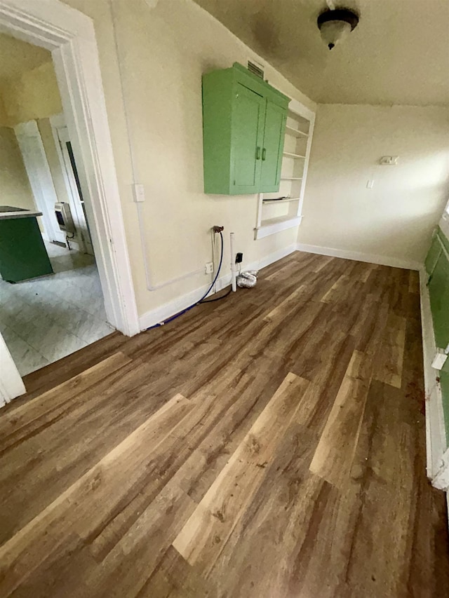 laundry room featuring wood finished floors and baseboards