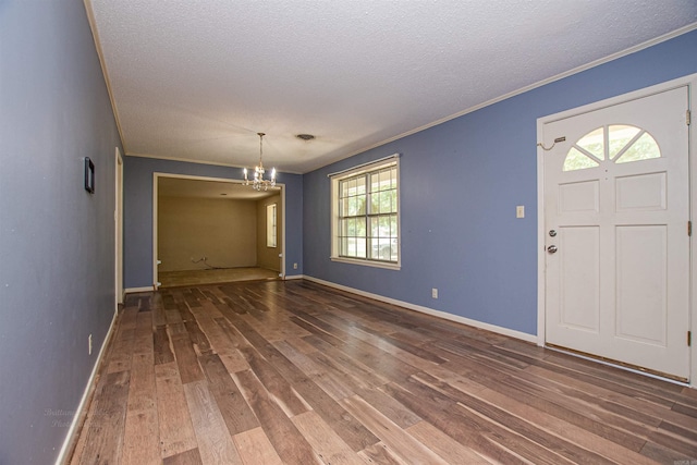 681 Sharp Ave, Camden, AR 71701 - entrance foyer with a chandelier, hardwood / wood-style flooring, crown molding, and a textured ceiling