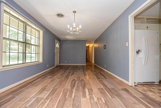 681 Sharp Ave, Camden, AR 71701 - empty room featuring a chandelier, wood finished floors, and ornamental molding