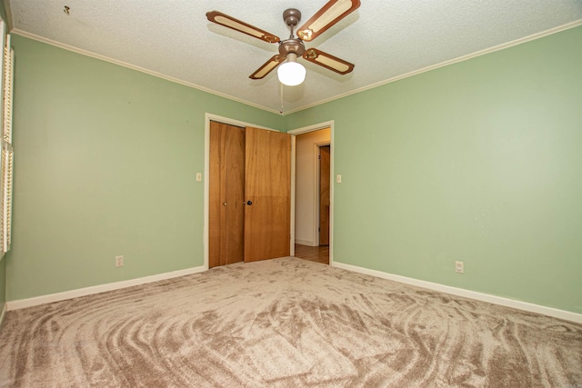 681 Sharp Ave, Camden, AR 71701 - unfurnished bedroom featuring ornamental molding, a textured ceiling, carpet flooring, a closet, and a ceiling fan
