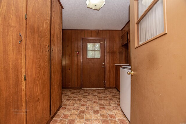 681 Sharp Ave, Camden, AR 71701 - doorway featuring wood walls, light stone finish floors, and a textured ceiling