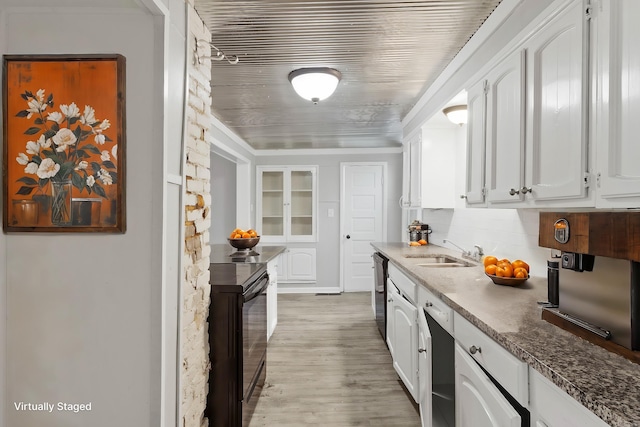 kitchen with dishwasher, black / electric stove, white cabinets, and a sink