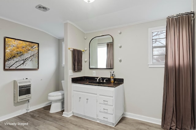 bathroom with crown molding, heating unit, visible vents, toilet, and wood finished floors