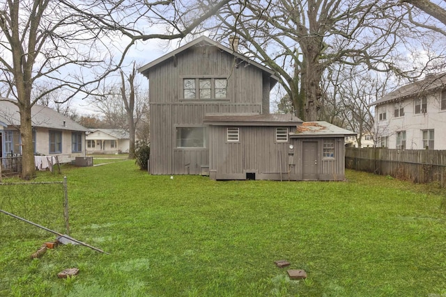 back of house with a yard and fence