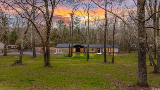 view of front of house featuring a porch and a yard