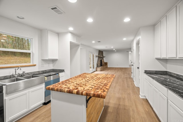 kitchen with white cabinetry, visible vents, stainless steel dishwasher, and recessed lighting