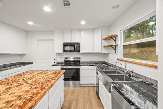 kitchen with stainless steel appliances, recessed lighting, visible vents, and white cabinets