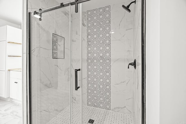 full bath featuring marble finish floor and a marble finish shower