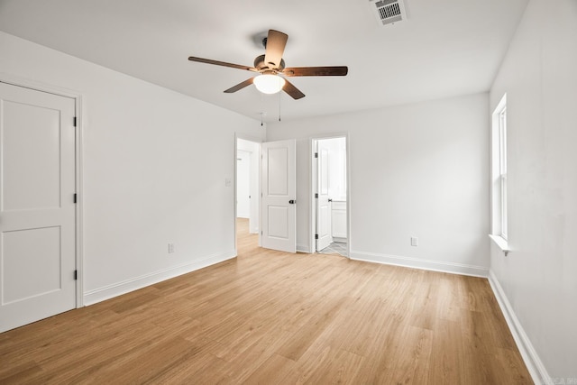 unfurnished bedroom featuring light wood finished floors, baseboards, visible vents, and a ceiling fan