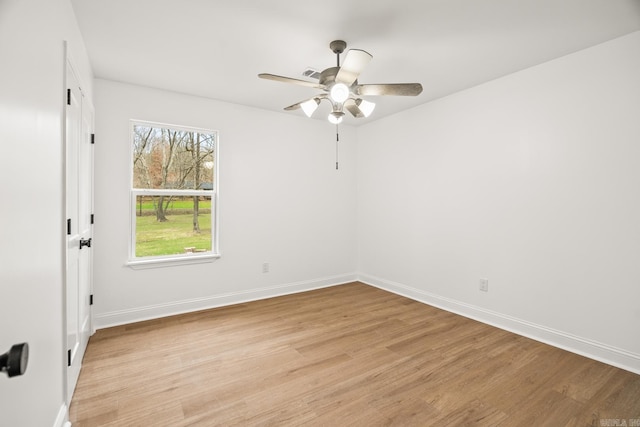 spare room featuring light wood-style flooring and baseboards