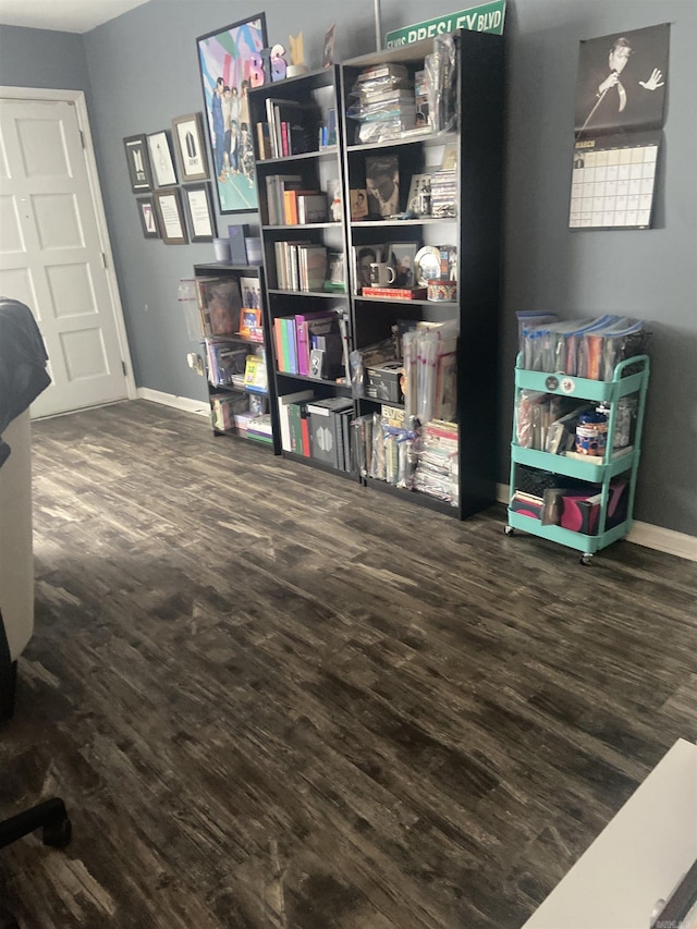 interior space featuring baseboards and wood finished floors