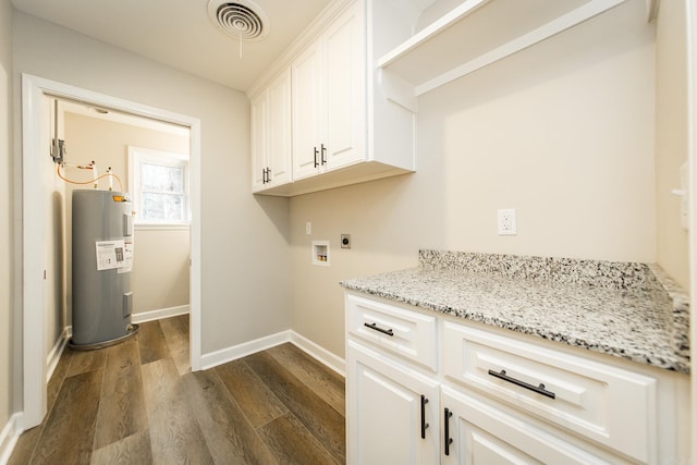 washroom with dark wood-style floors, hookup for a washing machine, electric water heater, hookup for an electric dryer, and baseboards