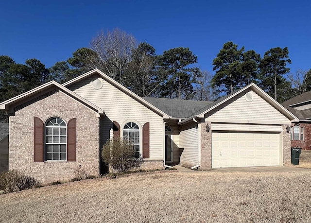 single story home with brick siding, driveway, and an attached garage