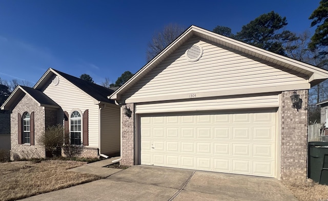 ranch-style home with concrete driveway and brick siding