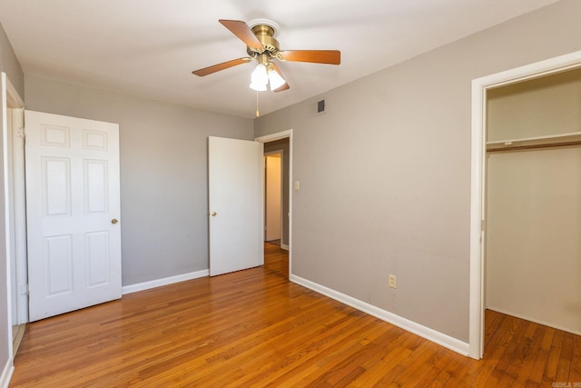 unfurnished bedroom featuring a closet, visible vents, a ceiling fan, light wood-type flooring, and baseboards