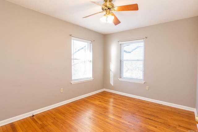 spare room with light wood-style flooring, baseboards, and ceiling fan