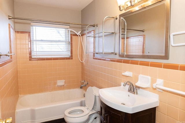 full bathroom with toilet,  shower combination, vanity, and tile walls