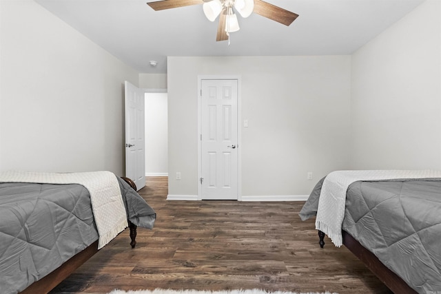 bedroom with wood finished floors, a ceiling fan, and baseboards