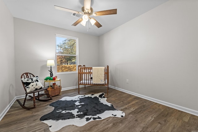 bedroom with visible vents, ceiling fan, baseboards, and wood finished floors