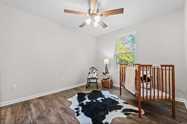 bedroom featuring baseboards and wood finished floors