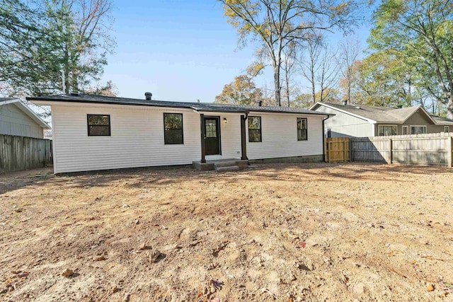 view of front of house with crawl space and fence