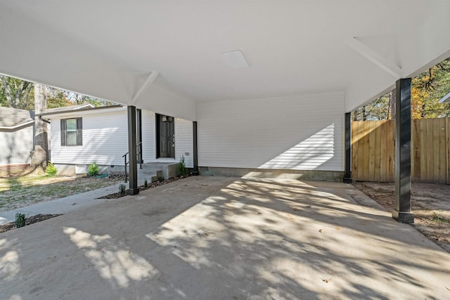 view of patio / terrace featuring driveway and fence